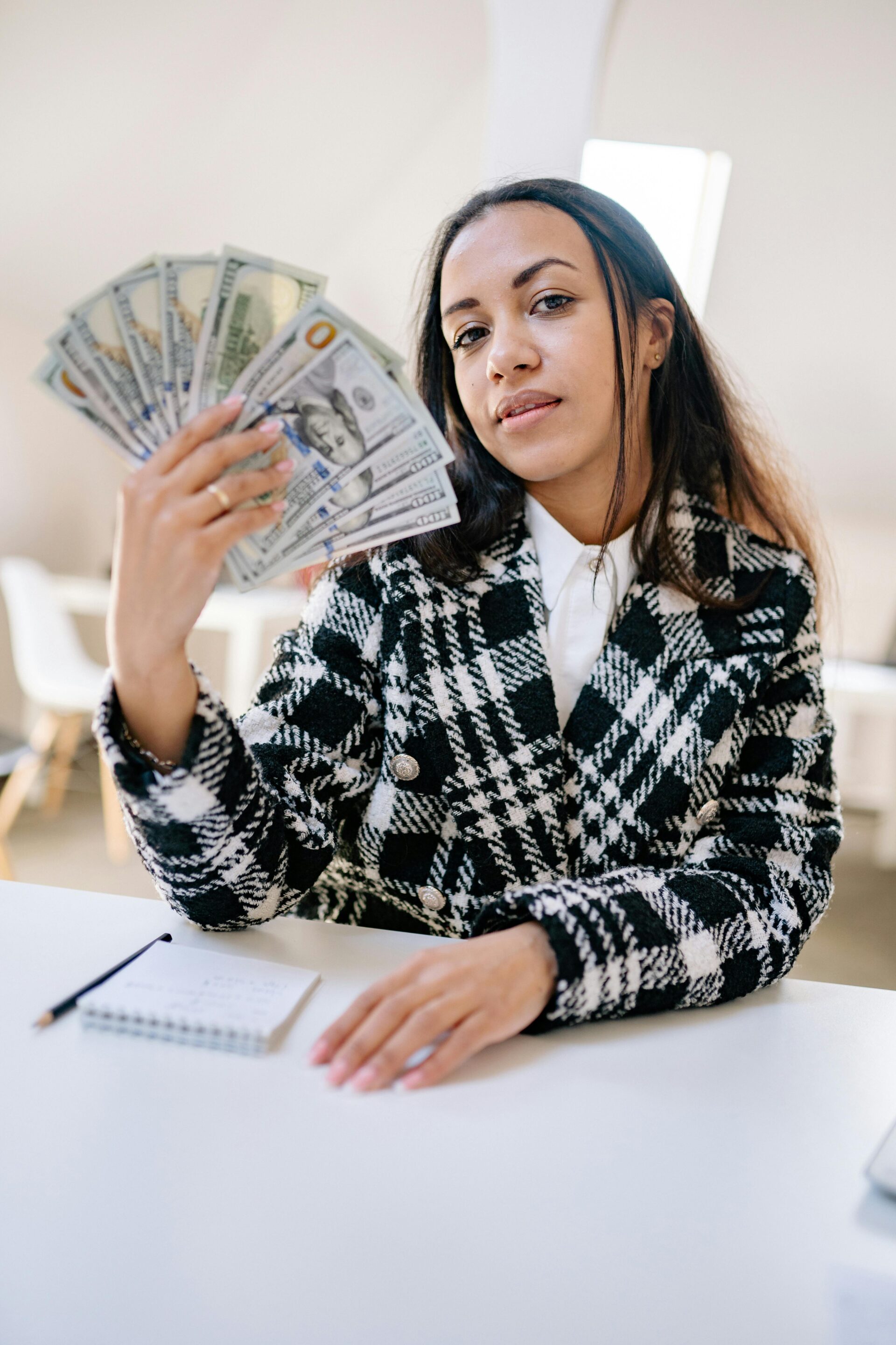 Black woman holding cash, representing funding opportunities for August 2025 grants in New York