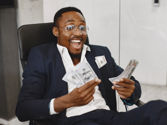 Person holding money representing September 2025 grants in New York for community projects and organizations.